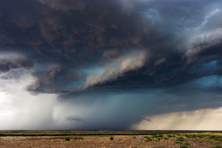A powerful storm with a vibrant, turquoise hail core drifts across the plains of eastern colorado.