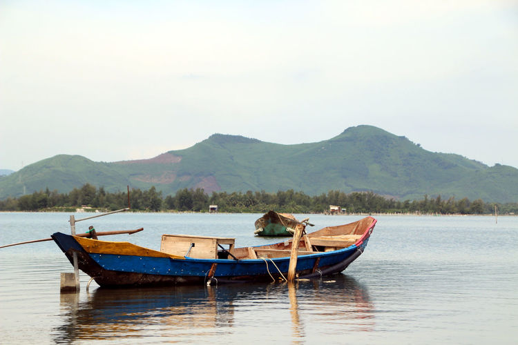 Boat in lake against sky