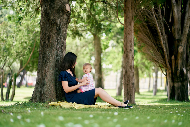 Mother with baby sitting at park