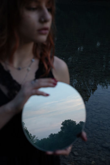 Reflection of woman in lake
