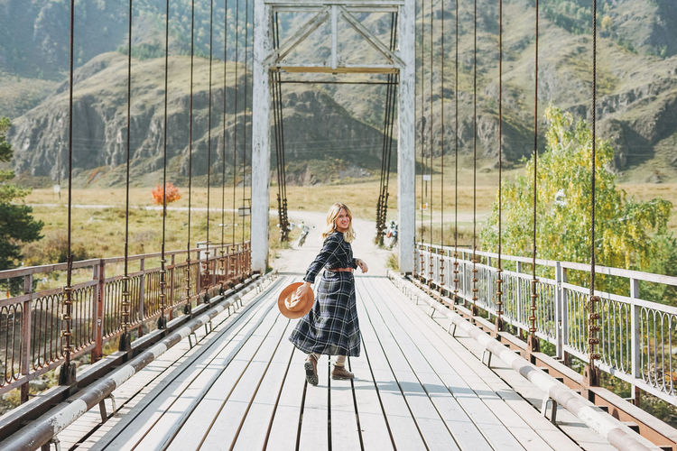Woman walking on footbridge