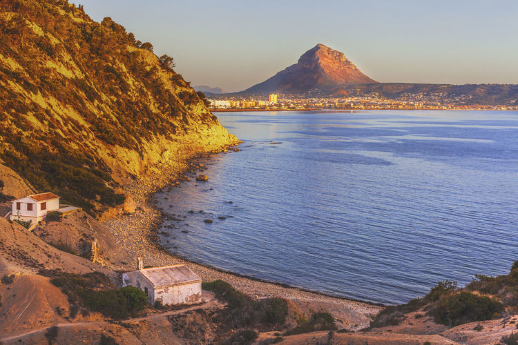 Sunrise at cap prim looking out towards the town of javea, alicante, spain.