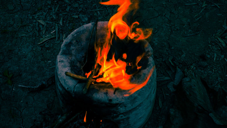 Cooking on a traditional stove while camping in the baturaja forest of south sumatra, indonesia.