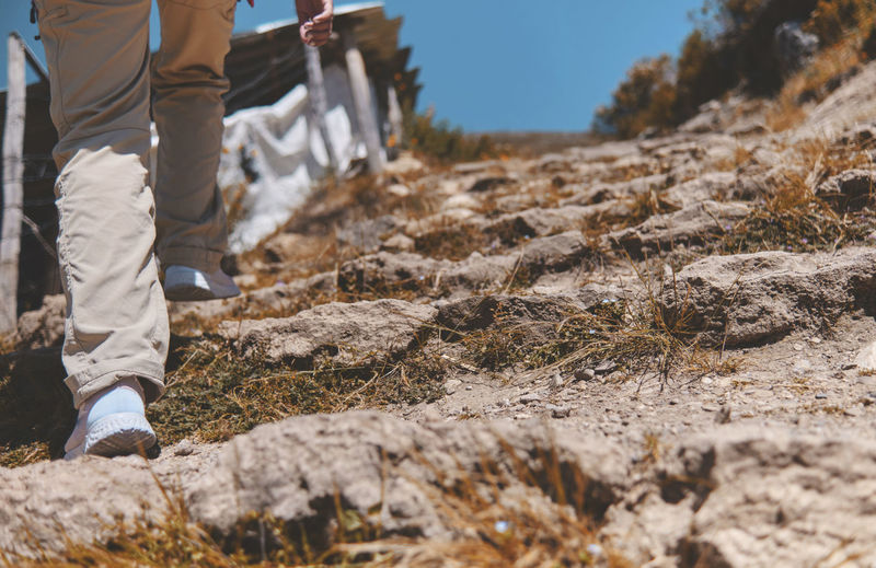 Young tourist walks on a path to the mountain. adventure travel, hiking concept