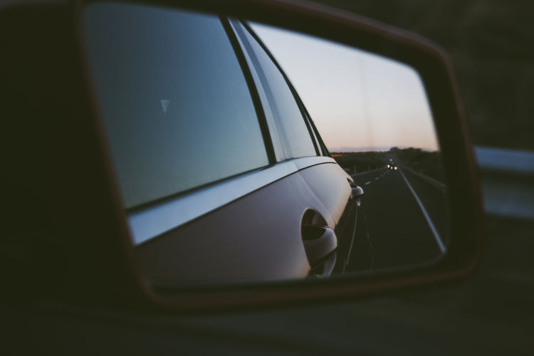 Reflection of car on side-view mirror