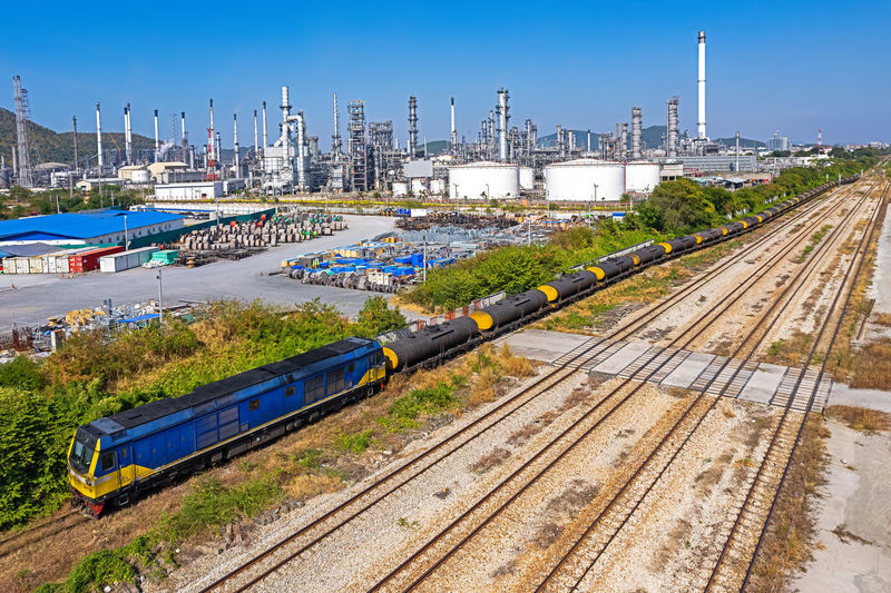 The train transports oil as it passes through the refinery.