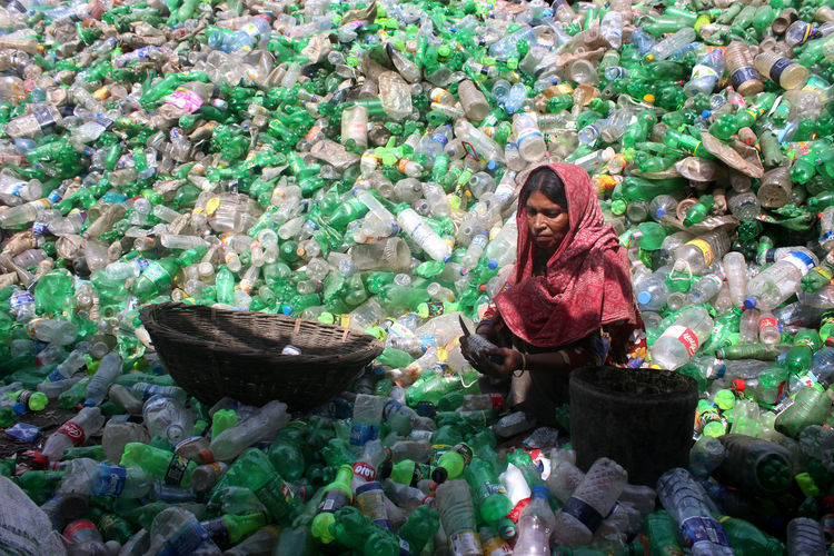 Portrait of smiling woman working with plastic