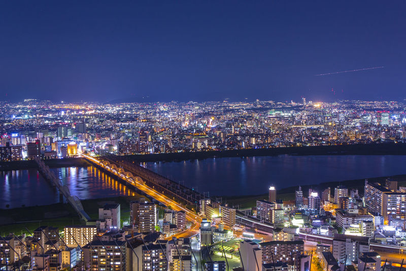 High angle view of illuminated buildings in city at night