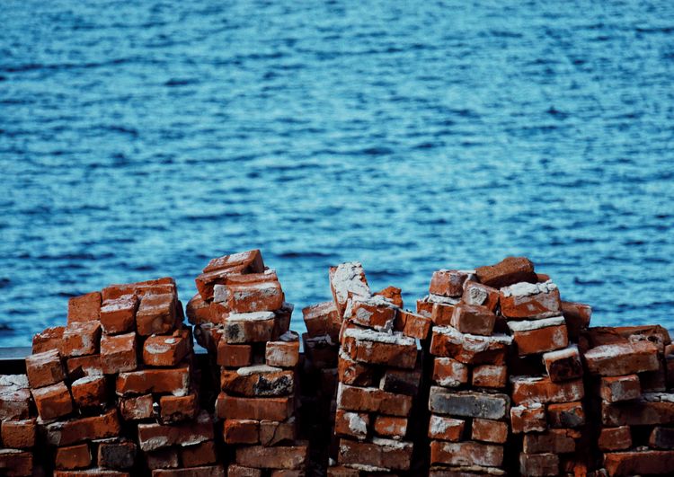 Close-up of bricks next to water 