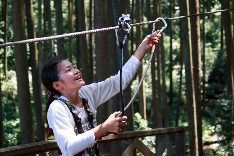 Happy teenage girl holding rope