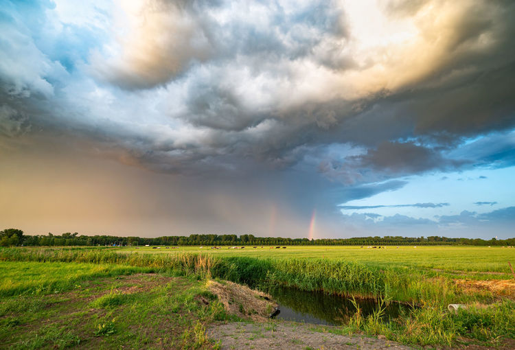 Rainbow with dramatic looking sky at the back of a severe thunderstorm over the dutch plains
