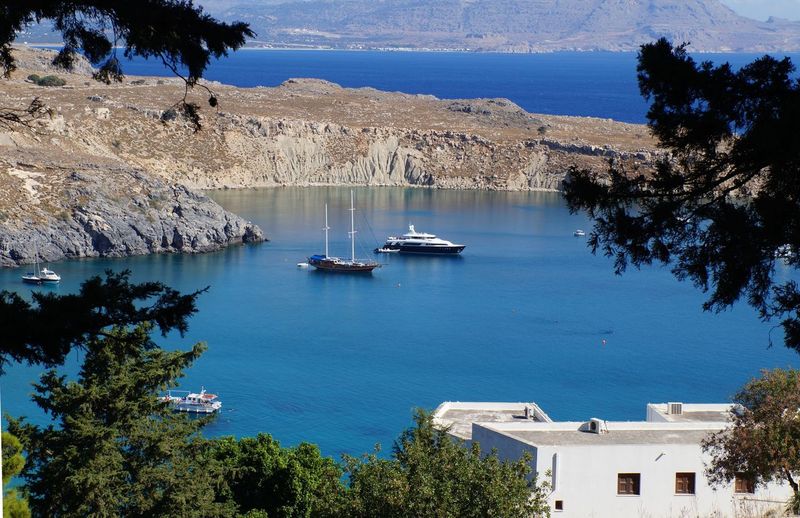 High angle view of boats sailing on sea at island