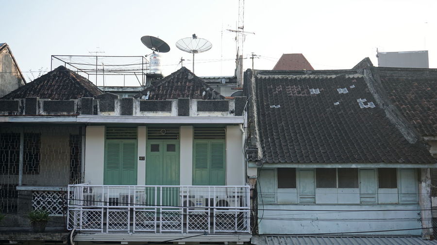 Buildings in city against clear sky