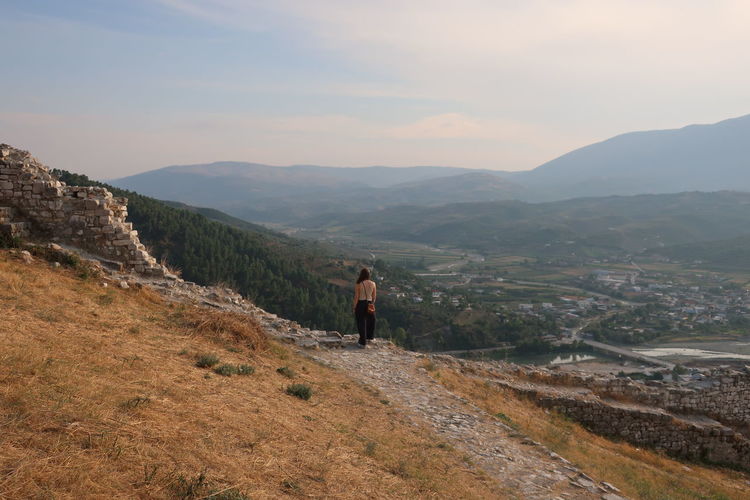 Woman standing on mountain against sky in berat, albania