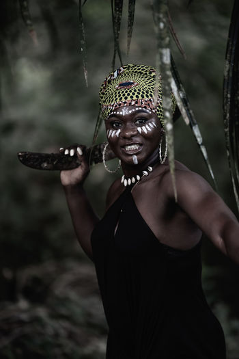 African woman hunting with a boomerang in the tropical jungle ghana west africa