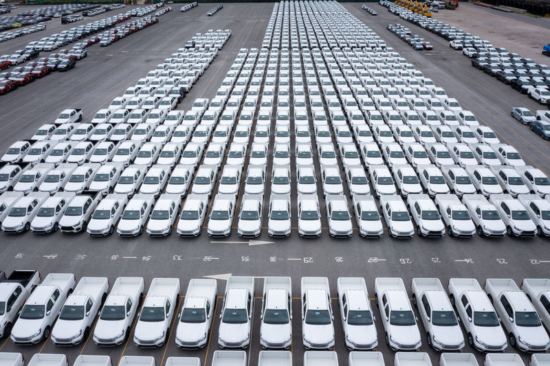 Aerial front view new cars lined up parked in a row in warehouse at the commercail dock 