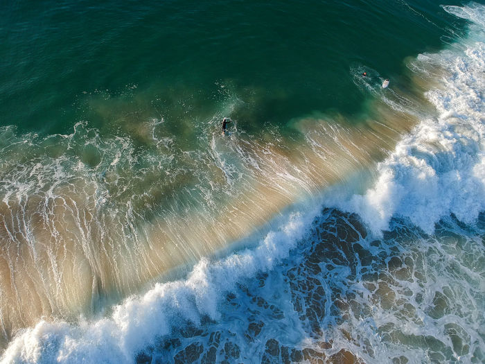 Aerial view of waves splashing at coast