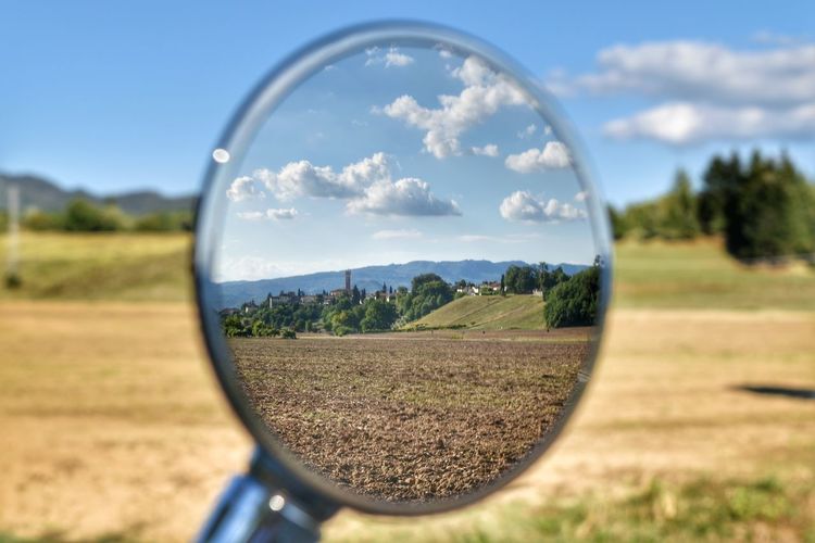 Scenic view of field seen through glass