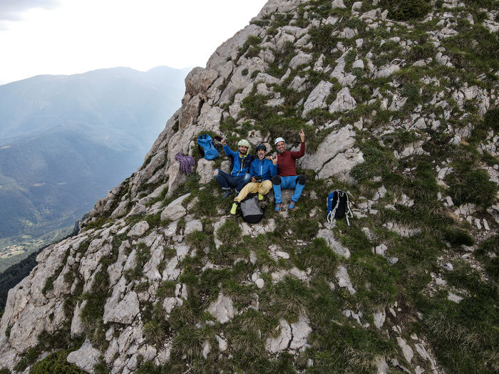 Climbers on rocks against mountain range