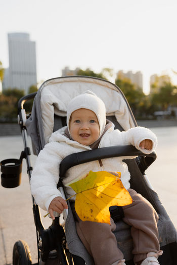 Cute baby in carriage outdoors