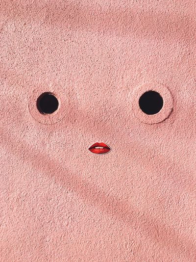 Anthropomorphic face made on pink wall