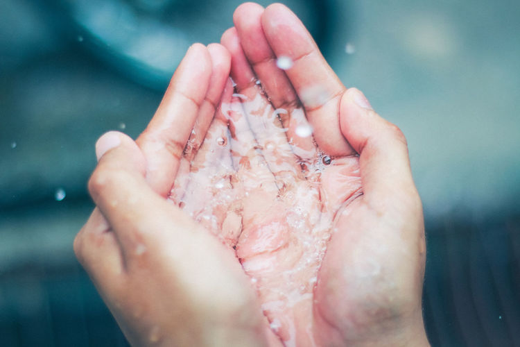 Close-up of person holding water in hand