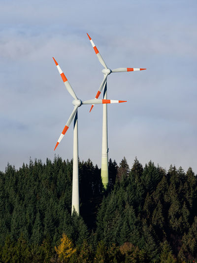 Windmills / wind turbines on a hilltop above the clouds in the black forest, germany