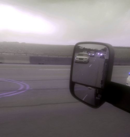 Close-up of car on road against sky