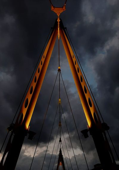 Low angle view of illuminated bridge against sky