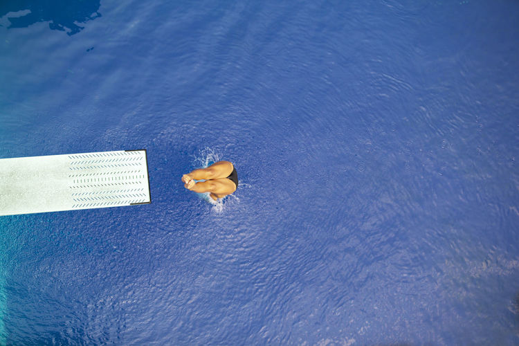 High angle view of woman diving into water