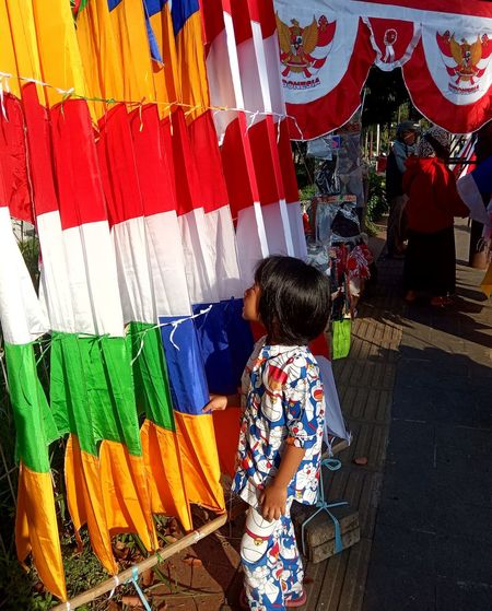 Side view of girl looking at colorful decorations