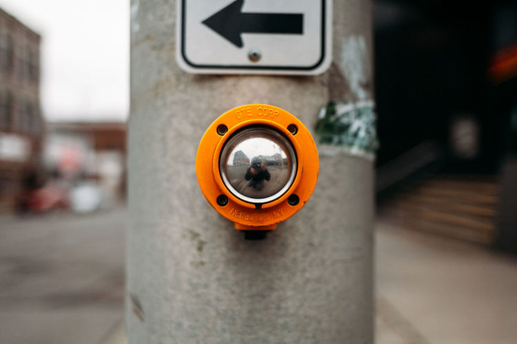 Eye level view of yellow walk button.