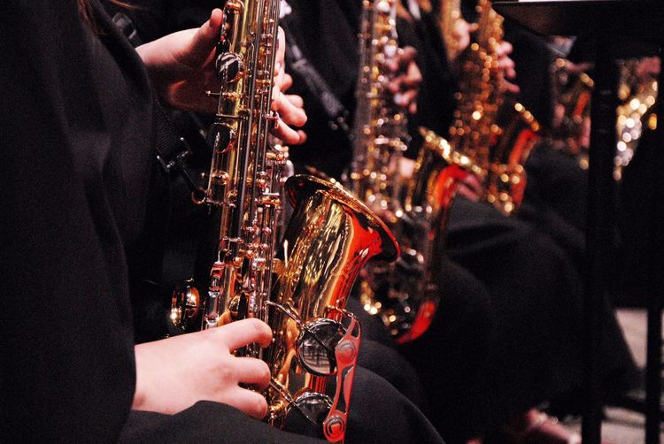 Cropped image of musician playing saxophones