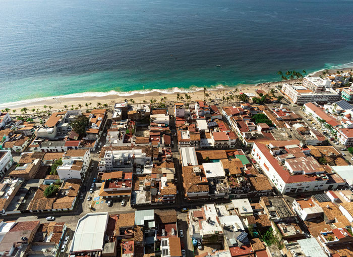 High angle view of buildings and sea in city