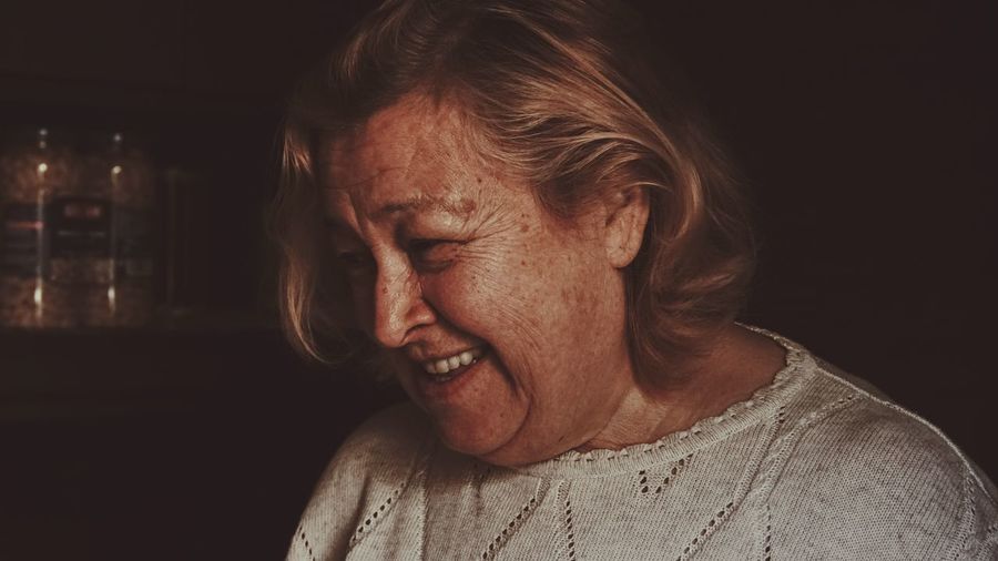 Close-up of smiling senior woman at home