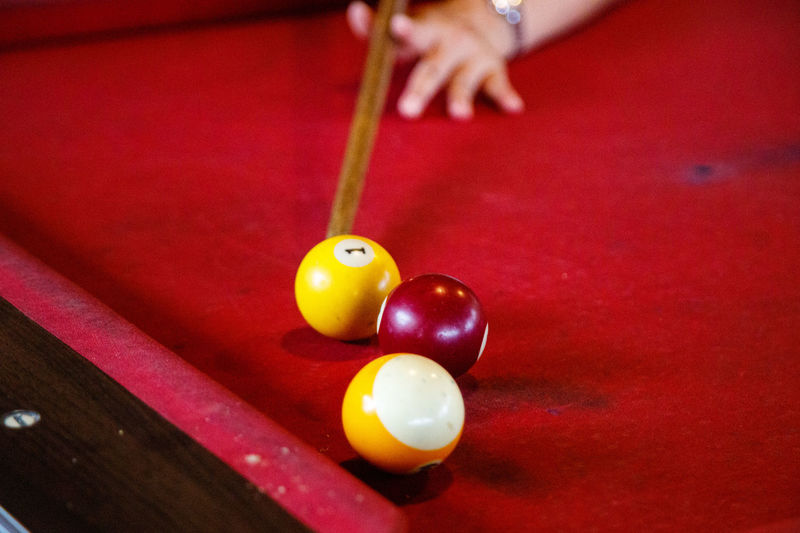 Cropped hand of person playing pool