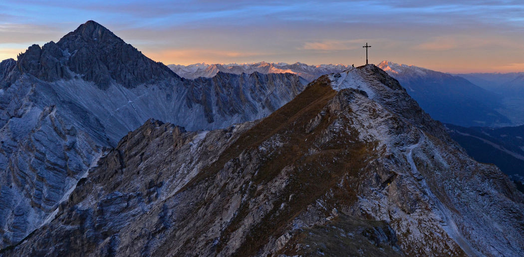 Scenic view of snowcapped mountains against sky during sunrise