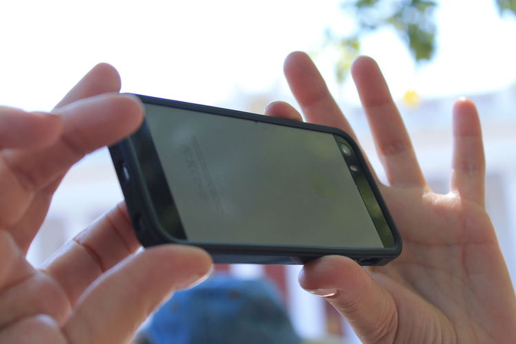 Cropped hands holding mobile phone