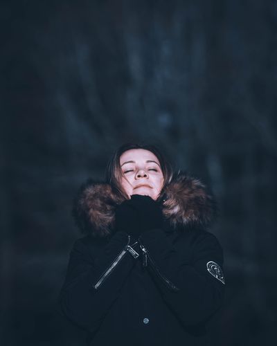 Woman with eyes closed enjoying cold weather