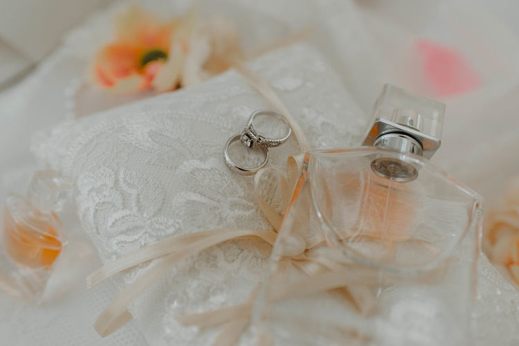 Close-up of wedding rings on white table