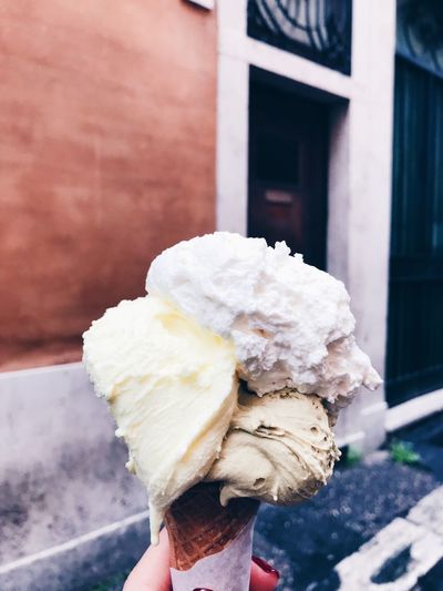 Cropped hand of woman holding ice cream cone