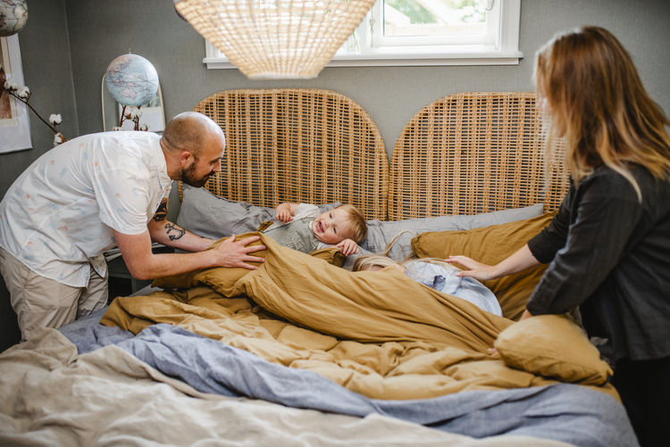 Parents and toddler boy in bedroom