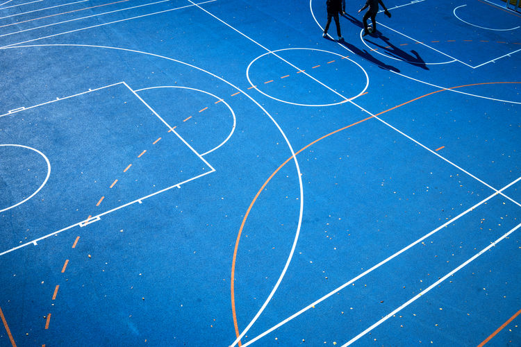 Low section of basketball hoop against blue sky