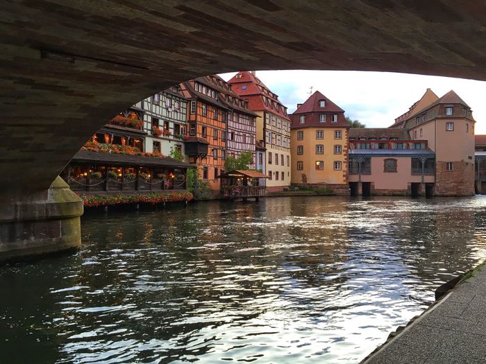 Buildings by river in city