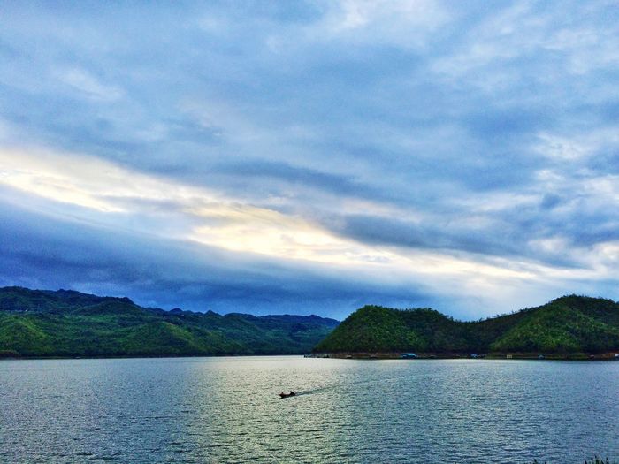 Scenic view of lake against cloudy sky