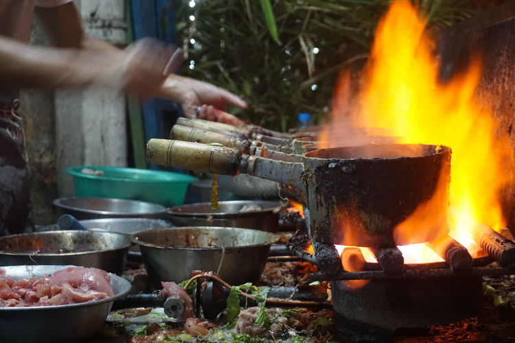 View of person cooking on fire outdoors