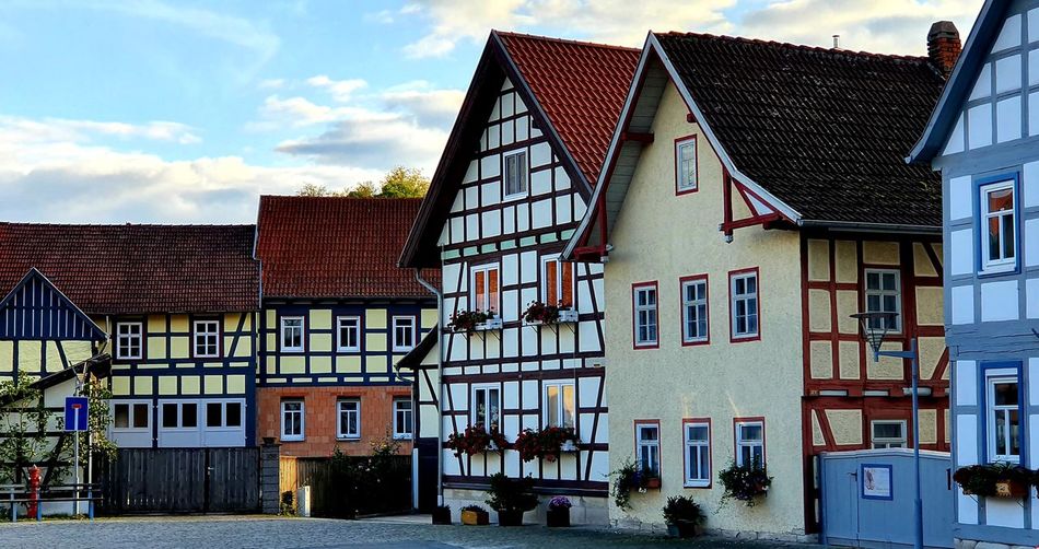 Low angle view of buildings in town against sky