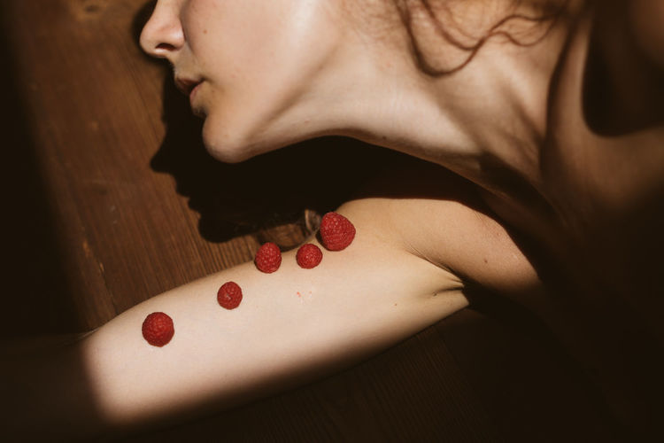 Midsection of woman with red berries