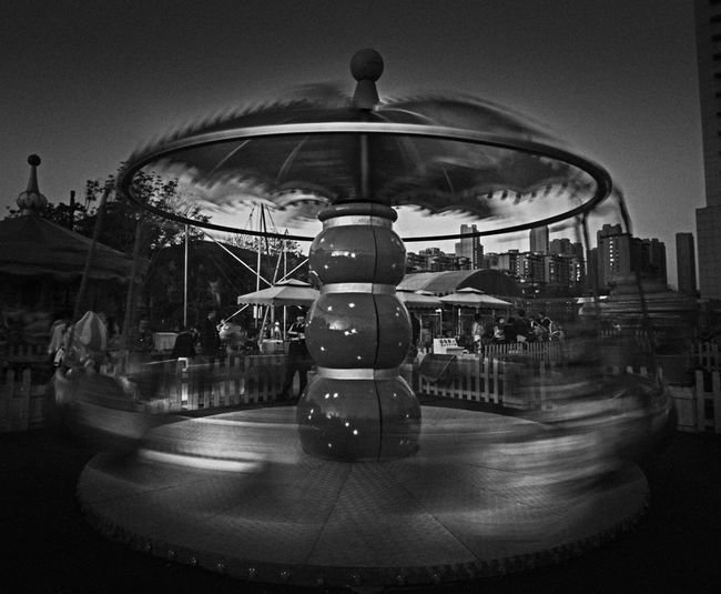 Blurred motion of amusement park ride against sky