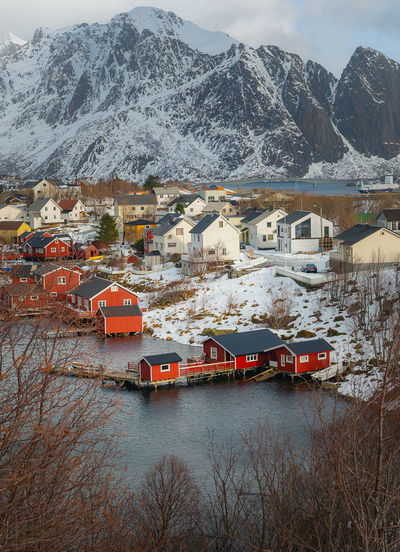 Buildings by mountains during winter